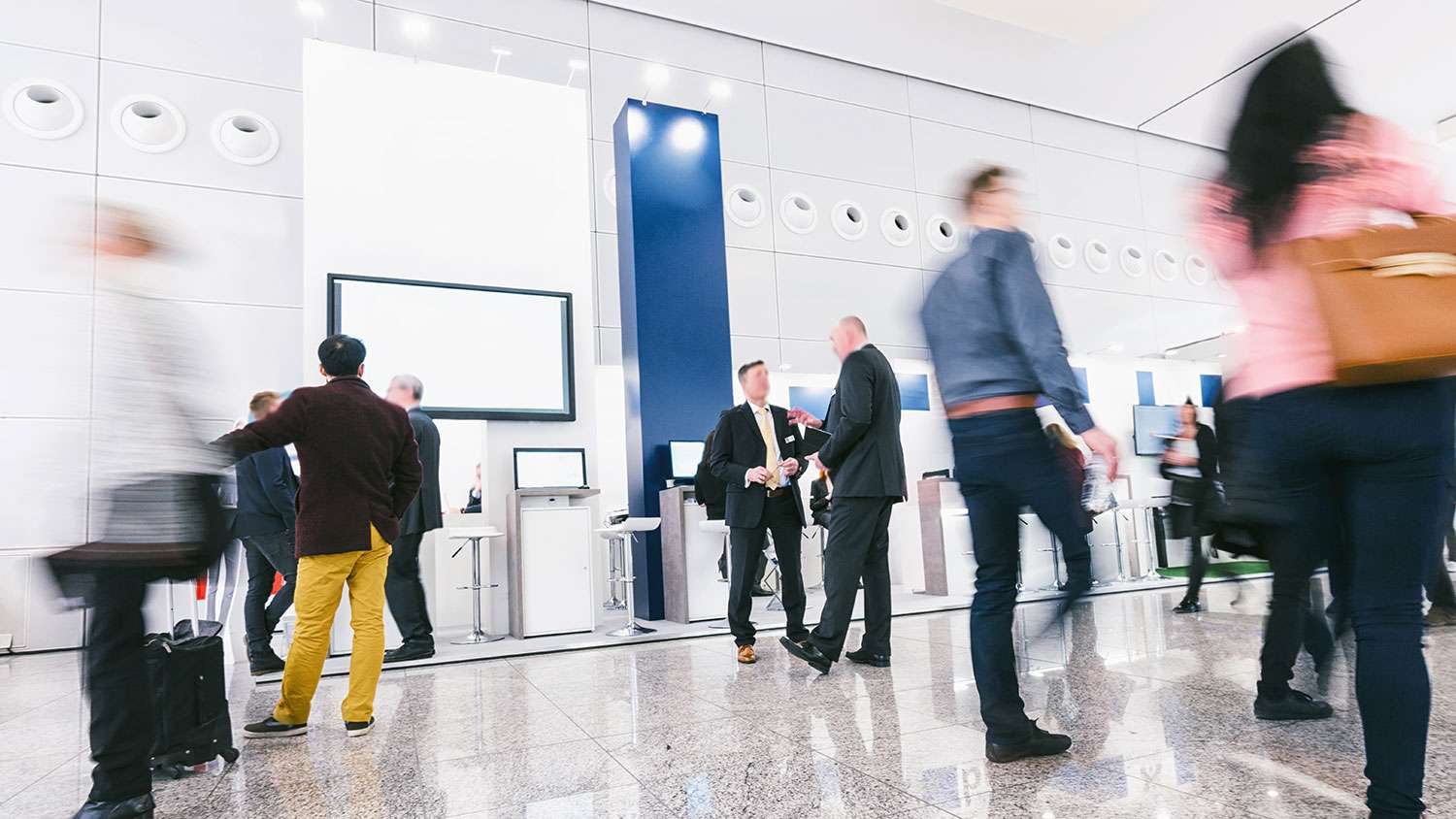 Crowd of business people at a trade show booth